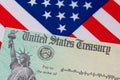 United States Treasury check and American flag Royalty Free Stock Photo