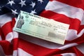 United States Treasury Refund check on waving American Flag Royalty Free Stock Photo