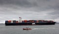 United States US Coast Guard boat next to a cargo ship getting close to Jersey dockyards Royalty Free Stock Photo