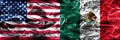 United States vs Mexico smoke flags concept placed side by side