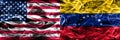 United States vs Venezuela smoke flags concept placed side by si