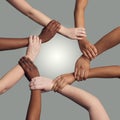 United together for a common cause. a group of hands holding on to each other at the wrist against a grey background. Royalty Free Stock Photo