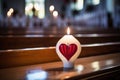 unity candle with heart-shaped flame in a church