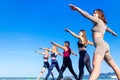 Unity group of women practic yoga on rhe beach in morning Royalty Free Stock Photo