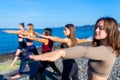 unity group of women practic yoga on rhe beach in morning Royalty Free Stock Photo