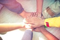 Unity and teamwork Concept: Group of students friends hands together. Top view of Asian young people putting their hand together