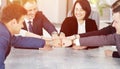 Unity and teamwork concept of young business people folding their hands together Royalty Free Stock Photo