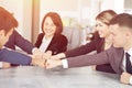 Unity and teamwork concept of young business people folding their hands together Royalty Free Stock Photo