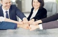 Unity and teamwork concept of young business people folding their hands together Royalty Free Stock Photo