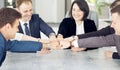 Unity and teamwork concept of young business people folding their hands together Royalty Free Stock Photo