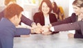 Unity and teamwork concept of young business people folding their hands together Royalty Free Stock Photo