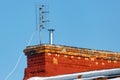 Universal antenna for receiving analog TV signal is installed on the roof of a brick house