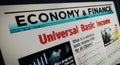 Universal basic income analysis technology newspaper on mobile tablet screen