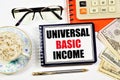 Universal basic income. A text label in the planning notebook. Royalty Free Stock Photo