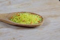 Universal bulk seasoning for dishes on a wooden background. Vegeta
