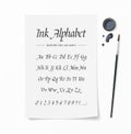 Universal handwritten font. Hand drawn alphabet written with brush pen. White paper, inkwell, ink drops on desk top view Royalty Free Stock Photo