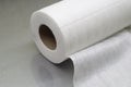 Universal white fabric napkins for cleaning in a roll. Bobbin with napkins for dispenser. Selective focus