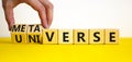 Universe or metaverse symbol. Businessman turns wooden cubes and changes the word universe to metaverse. Beautiful yellow table