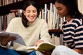 University, books or happy women at campus library for reading research, project or homework. College, education and Royalty Free Stock Photo
