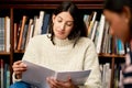 University, books and women at campus library for reading research, project or homework. College, education and gen z Royalty Free Stock Photo