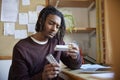 University Or College Student With Poor Mental Health Looking At Anti Depressant Medication Packaging At Desk In Room Royalty Free Stock Photo