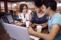 University, discussion and students in library on laptop for research, studying and online learning. Education, college Royalty Free Stock Photo