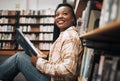 University, education and black woman in library reading book. College scholarship, student and happy female learner Royalty Free Stock Photo