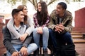 University, education and friends on campus in conversation, talking and chatting outdoors. Diversity, community and Royalty Free Stock Photo