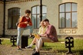 University friends chilling outdoors, young people having nice conversation Royalty Free Stock Photo