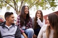 University, friends and people laugh on campus in conversation, talking and chatting outdoors. Diversity, learning and Royalty Free Stock Photo