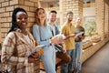 University, hallway and portrait happy students standing in row together with book, tablet and smile at business school Royalty Free Stock Photo