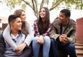 University, happy and friends on campus stairs in conversation, talking and chatting outdoors. Diversity, education and Royalty Free Stock Photo