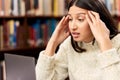 University, laptop or woman with stress headache at campus library for research, planning or homework assignment Royalty Free Stock Photo