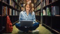 University Library Study: Smart Beautiful Caucasian Girl Sitting Cross-Legged On Floor, Uses Lapto Royalty Free Stock Photo