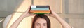 University research. Pretty woman working home. Girl portrait with book on head