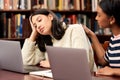 University, stress and women with laptop, support or comfort at campus library with research, fear or burnout. Education Royalty Free Stock Photo