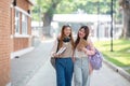 University student girl friends with learning book college while walking in campus Royalty Free Stock Photo