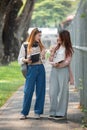 University student girl friends with learning book college while walking in campus Royalty Free Stock Photo