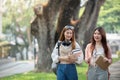 University student girl friends with learning book college while walking in campus Royalty Free Stock Photo