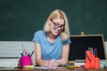 University student going to college. Teacher in classroom. Student preparing for test or exam. Young woman sitting at Royalty Free Stock Photo