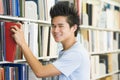 University student selecting book from library she Royalty Free Stock Photo