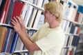 University student selecting book from library Royalty Free Stock Photo