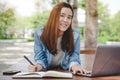 University student using internet search data for doing homework from computer in campus Royalty Free Stock Photo