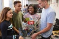 University Students Carrying Machine In Science Robotics Or Engineering Class