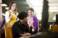 University students conversing by library computer