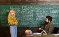 University students doing group study. Teenage female student preparing for exams at college classroom. Old books on a Royalty Free Stock Photo