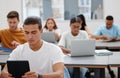 University, students and learning with laptop or tablet for digital notes in education auditorium. Concentration, focus Royalty Free Stock Photo