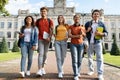 University Students Life. Group Of Multiethnic Young People Walking Together Outdoors Royalty Free Stock Photo