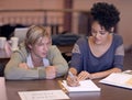 University, students and people in library with books for studying, learning and research for knowledge. Education Royalty Free Stock Photo