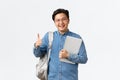 University, study abroad and lifestyle concept. Satisfied happy asian male student in glasses and shirt showing thumbs Royalty Free Stock Photo